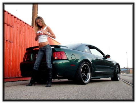 1998 Ford Crown Victoria - Woman poses with a green Ford Mustang GT coupe, likely from the early 2000s.
