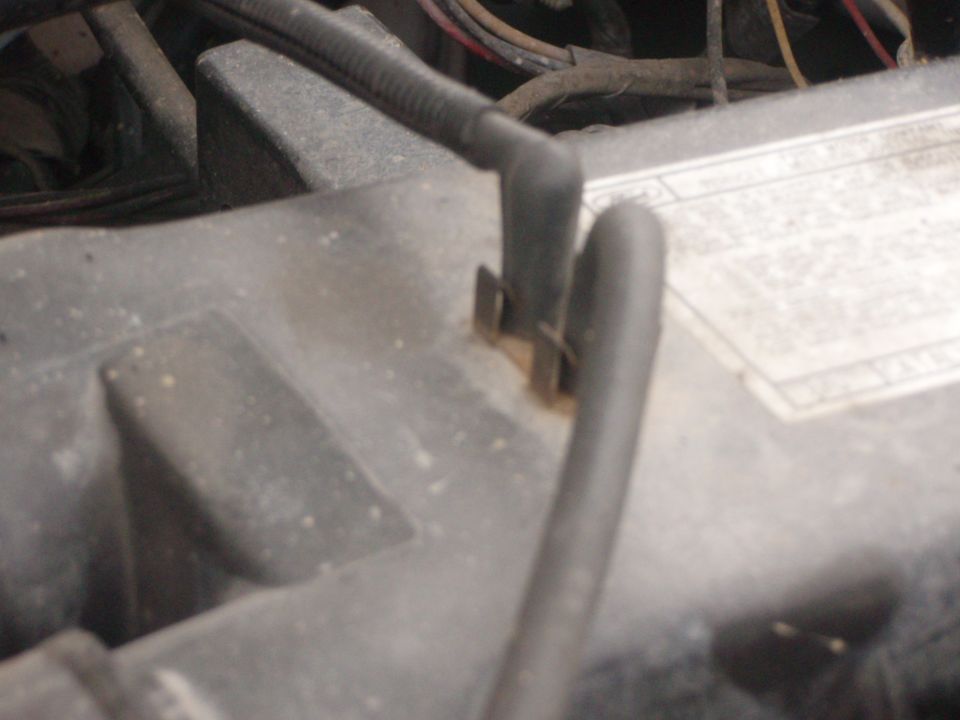 Close-up of engine bay with wires and a label visible