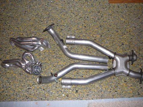 1997 Mercury Grand Marquis - Aftermarket exhaust headers and pipes are shown before installation.