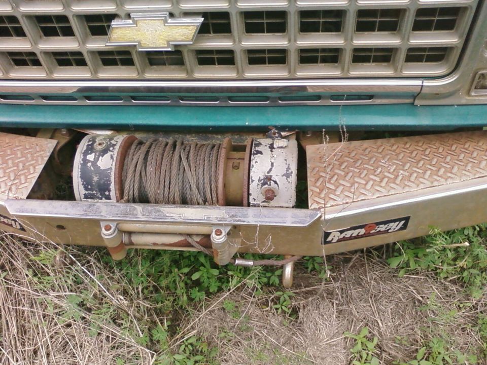Teal Chevy truck front with diamond-plate bumper and Ramsey winch