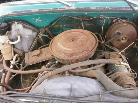1979 Chevrolet Cheyenne - Close-up view of a vehicle's engine bay, showing various components and hoses.