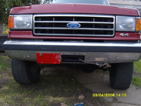 1989 Ford Bronco - Front view of a 1989 Ford Bronco, showing the grille, headlights, and a winch installed on the bumper.