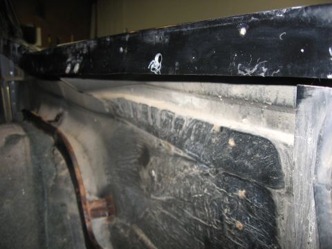 1989 Ford Bronco - Close-up view of the interior of a vehicle's wheel well, revealing the tire and liner.