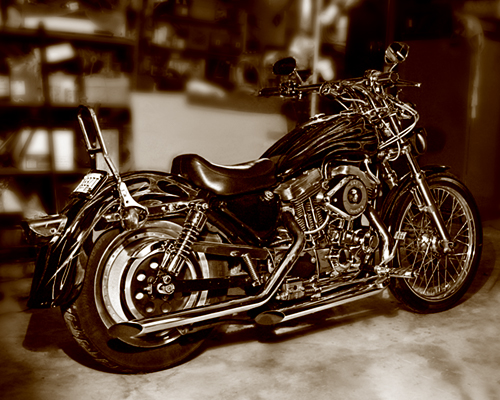 Motorcycle with flames on tank, chrome details, and spoked front wheel