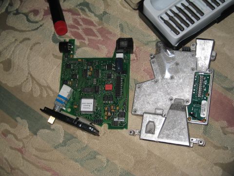 2007 Subaru Impreza - Disassembled electronic components and tools laid out on a patterned surface.