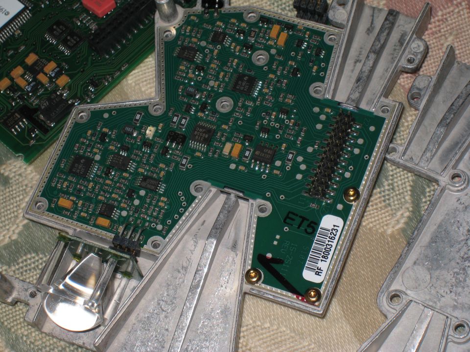 Circuit boards with electronic components and heatsinks, one labeled RF 1800316231