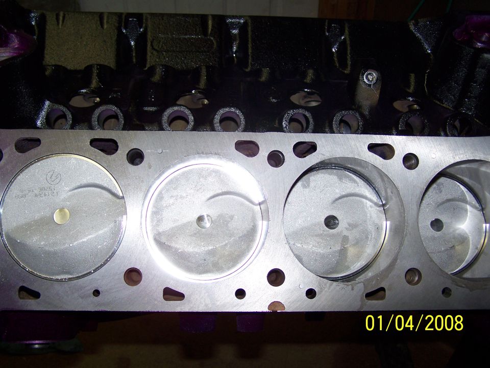 Engine block with four visible pistons and cylinder bores. Date stamp reads 01/04/2008