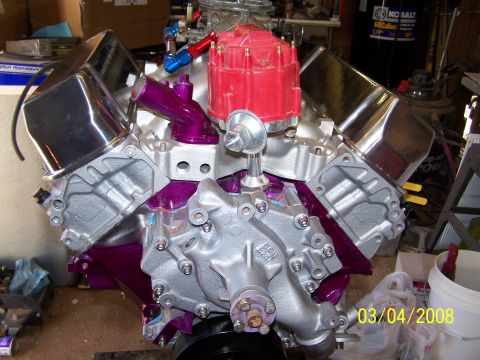 1995 Ford Bronco - Customized V8 engine assembly with aftermarket parts, photographed in a garage setting.