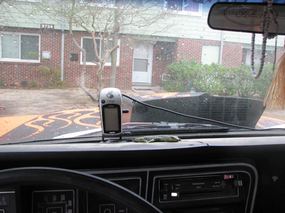 Vehicle dashboard with Garmin GPS and gauges, orange flames on hood visible through windshield