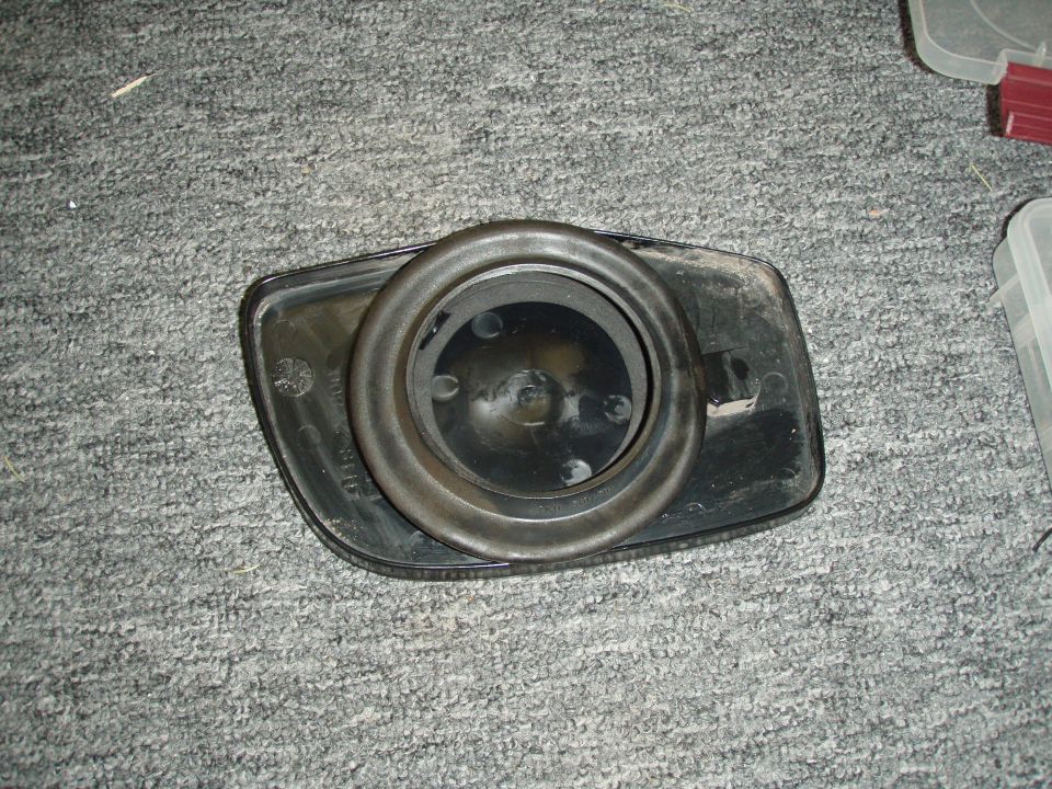 Black plastic light or speaker housing on carpet