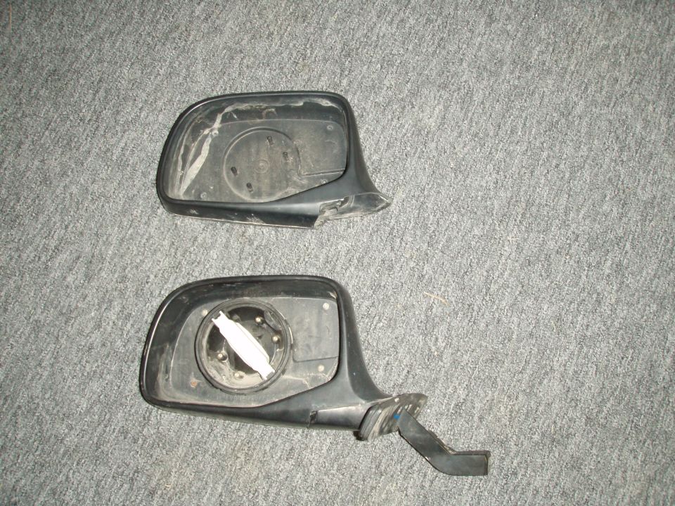 broken mirror housing with mirror motor removed. (top)
manual mirror housing from the junk yard. (bottom)

i managed to come close enough to a tree to snap the mirror clean off. (the plastic, even the metal interior rod)

i put my mirror motor into the new mirror housing i found at the junk yard.