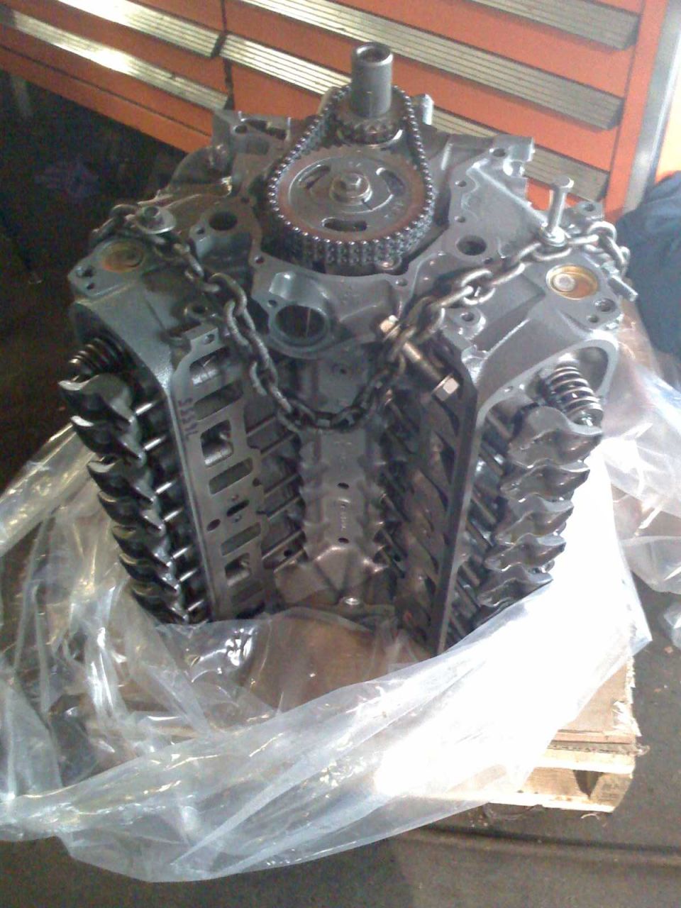 Engine block partially covered in plastic wrap