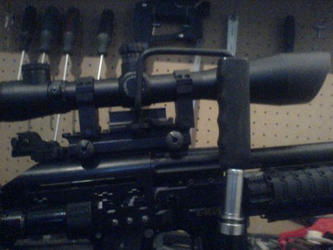 1985 Ford Bronco - This is a close-up view of a sniper rifle scope and its mounting system.