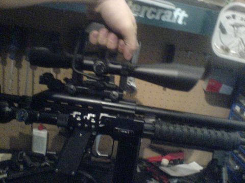 1985 Ford Bronco - A close-up view of a rifle scope attached to a gun.