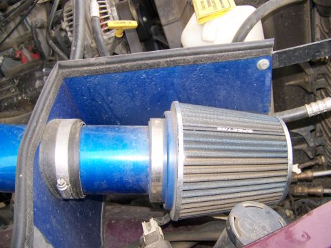 2001 Dodge 1500 - Close-up of a blue intake pipe connected to a silver air filter, likely part of an engine system.