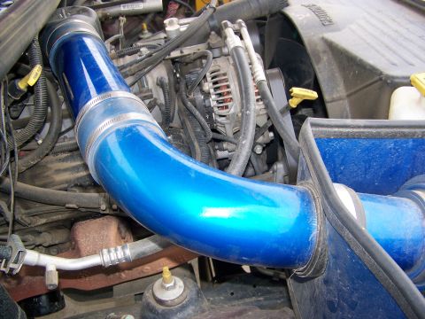 2001 Dodge 1500 - Blue intake pipe installed in an engine bay, showing engine components.