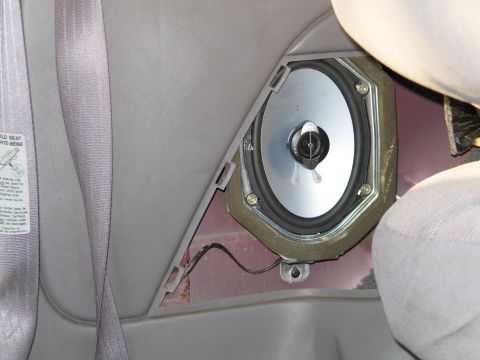 1995 Ford Bronco - Rear door speaker and seatbelt in a vehicle interior.