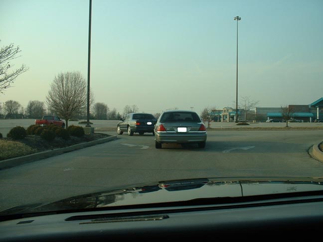 Gray Ford Crown Victoria from rear, parked in a lot