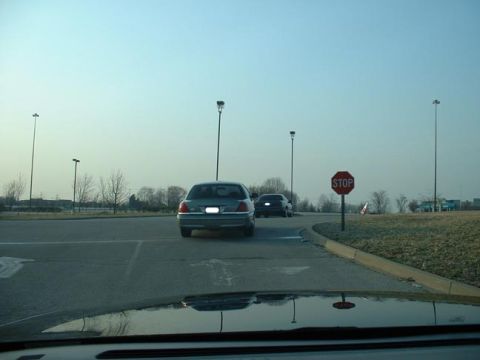 1998 Ford Crown Victoria - A 1998 Ford Crown Victoria is seen from the rear, with another vehicle following, under a clear sky.