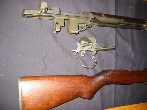 1996 Ford Bronco - Disassembled rifle parts including receiver, trigger group, and wooden stock.