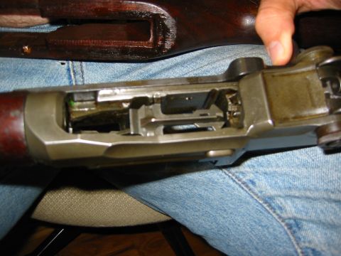 1996 Ford Bronco - The internal mechanism of an M1 Garand rifle is visible, with a person's hand operating a part.