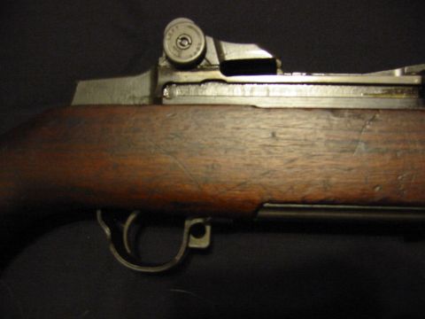 1996 Ford Bronco - A detailed view of a rifle's receiver and wooden stock, with a watermark at the bottom right.