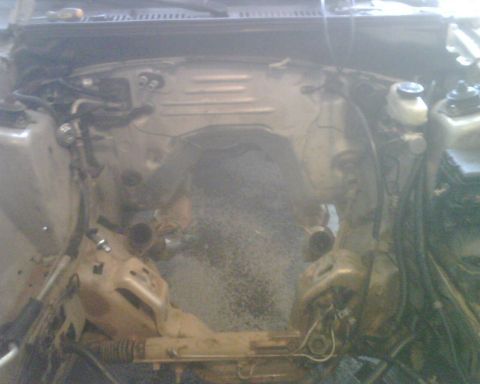 1999 Ford Mustang - The engine bay of a 1999 Ford Mustang, showing the space where the engine was removed.