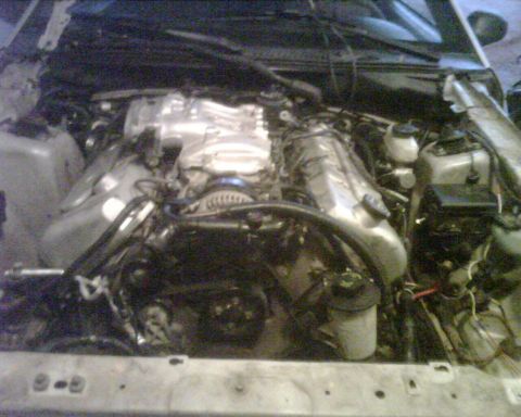 1999 Ford Mustang - The engine bay of a vehicle is shown with various mechanical parts and wiring visible.