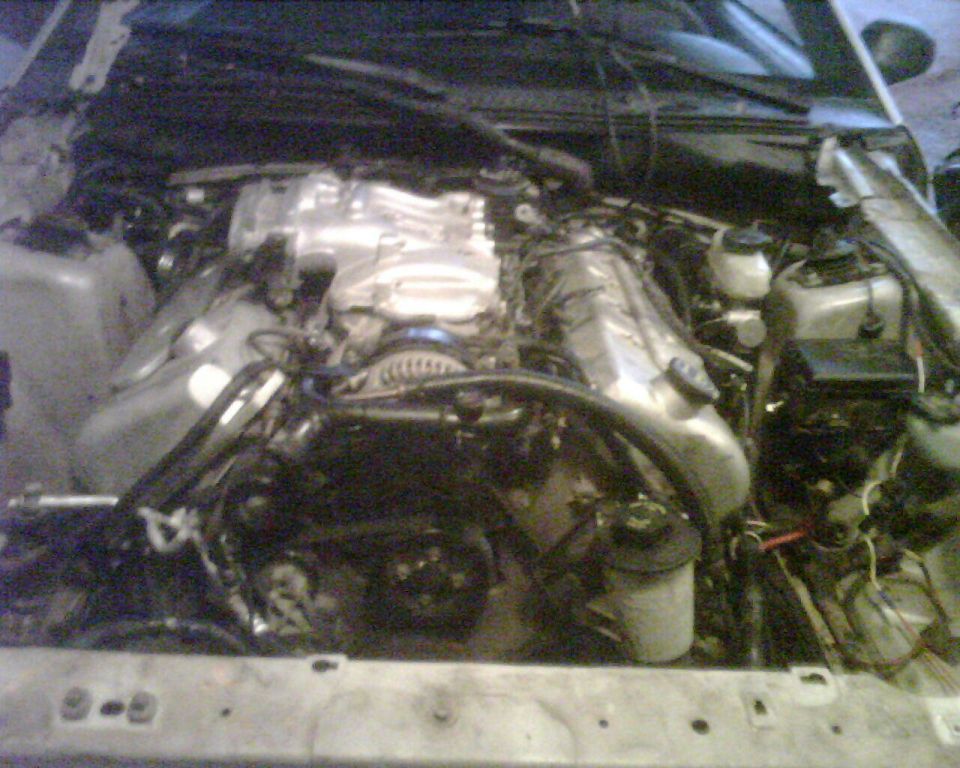 Engine bay with V8 engine and Supermotors.net logo