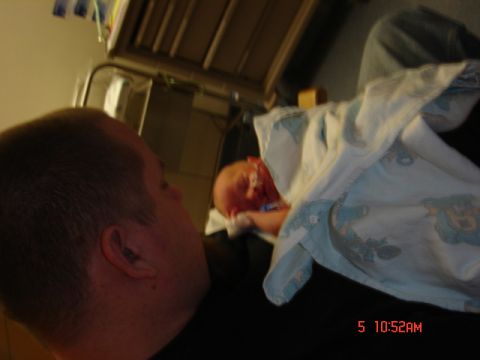1981 Ford Bronco - A father gazes at his newborn child, captured in a tender moment.