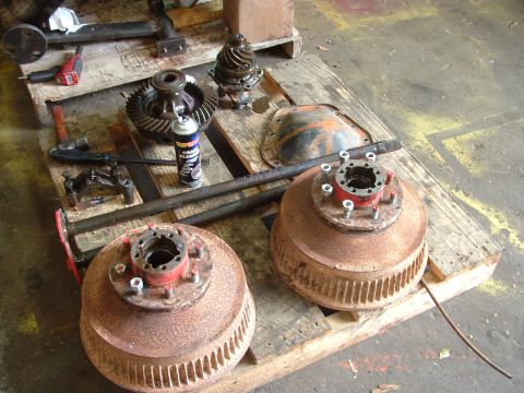 1979 Ford Bronco - Differential gears and brake drums laid out on a pallet, likely for a 1-ton swap project.