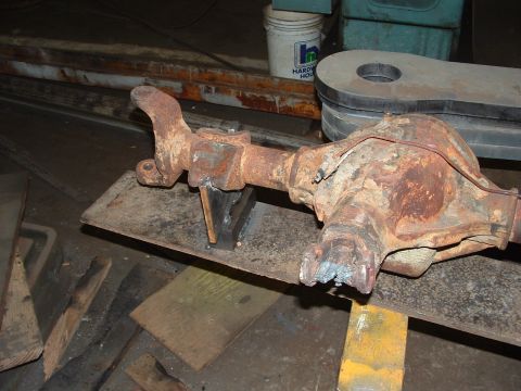 1979 Ford Bronco - A heavily rusted differential axle assembly is shown, indicating it is a vehicle part undergoing modification.
