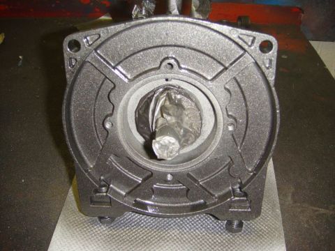 1996 Ford Bronco - A close-up view of a painted metal component, possibly a winch part, with a central shaft protected by foil.