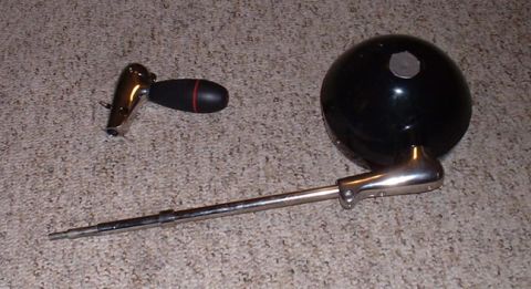 1998 Ford Crown Victoria - Car headlight and gear shift knob on carpeted surface.