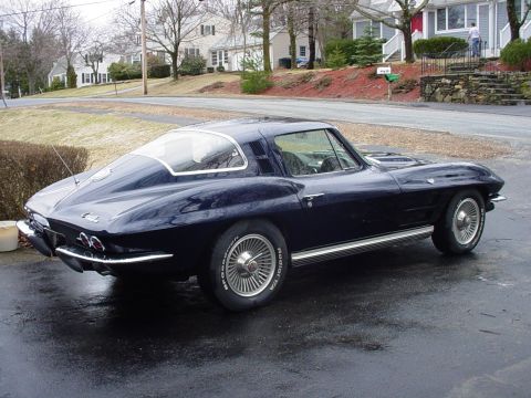 1964 Chevrolet Corvette - The rear quarter panel and distinctive split-window design are visible on this classic coupe.