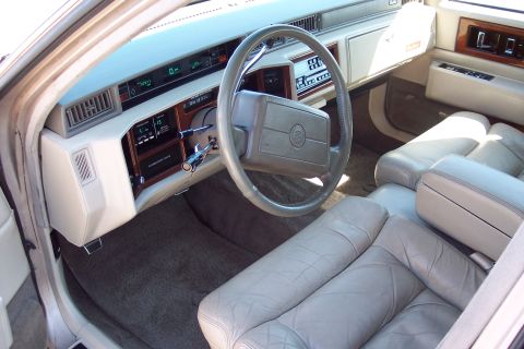 2001 Ford Crown Victoria - Interior view of a 1993 Cadillac Sixty Special, showing the dashboard, steering wheel, and front seats.