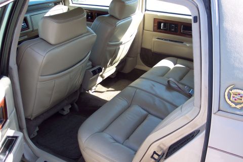 2001 Ford Crown Victoria - Interior view of a 1993 Cadillac Sixty Special, showing the rear seating area and door panel.