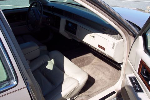 2001 Ford Crown Victoria - The interior of a Cadillac shows plush seating and a clean dashboard.
