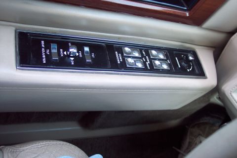 2001 Ford Crown Victoria - Interior door panel controls for seat adjustment, windows, and mirrors.