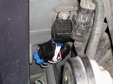 2003 Ford Crown Victoria - The relays mounted to the header panel bracket in front of the radiator and battery.