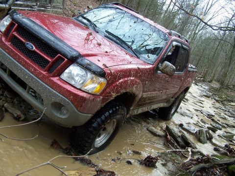 2002 Ford Sport Trac - This 2002 Ford Sport Trac is navigating a muddy, rocky path in a forest.