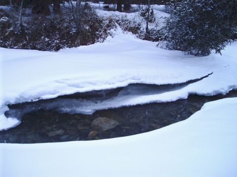 2000 Ford E350 - A winter scene shows a creek with snow and ice, with trees in the background.