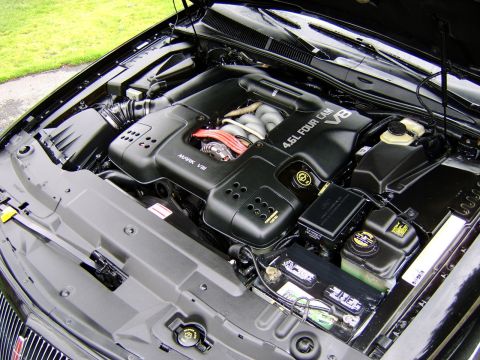 1996 Mercury Grand Marquis - The engine bay of a black 1996 Mercury Grand Marquis, a 4.6L V8 engine.