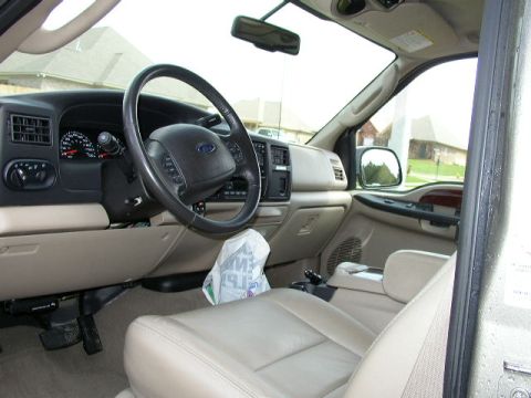 1995 Ford Bronco - Interior view of a Ford Super Duty truck, likely from the mid-2000s, with a prominent dashboard and steering wheel.