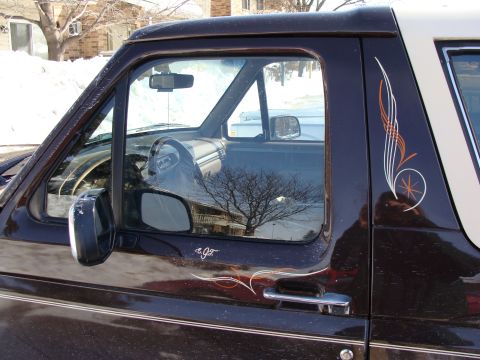 1992 Ford Bronco - This 1992 Ford Bronco features a two-tone paint scheme and custom pinstriping on the side.