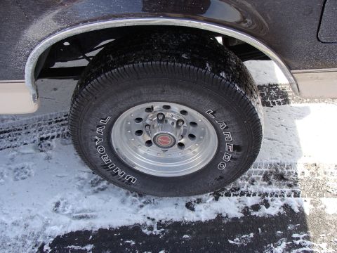 1992 Ford Bronco - Close-up of the rear wheel and fender of a 1992 Ford Bronco in snowy conditions.