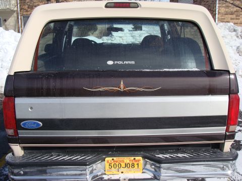 1992 Ford Bronco - This 1992 Ford Bronco is seen from the rear in a snowy environment, a two-tone paint scheme and a Polaris sticker on the rear window.