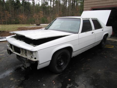 1991 Ford LTD Crown Victoria - This 1991 Ford Crown Victoria LTD is shown with its hood and trunk open, revealing its engine bay and rear storage.