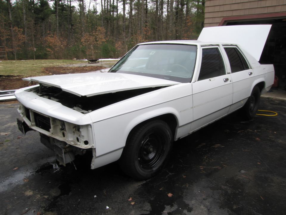 White 1991 Ford Crown Victoria LTD with hood and trunk open