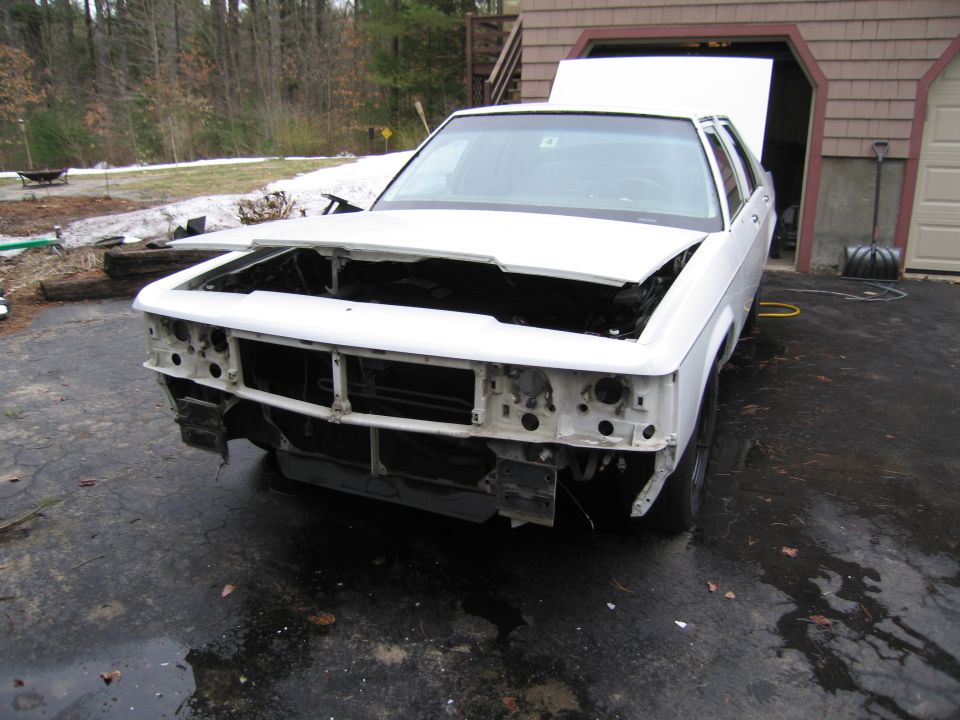 1991 Ford Crown Victoria LTD with hood and front bumper removed, parked in driveway
